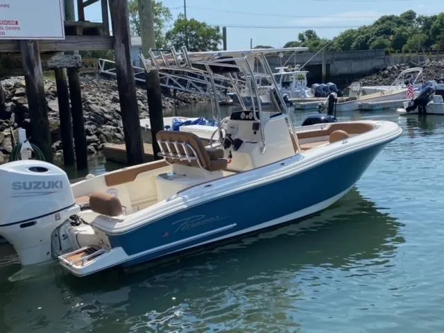 Slide: The Image of 2023 Pioneer 202 Sportfish boat docked, featuring Suzuki outboard motor. - 6
