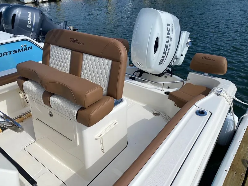 Slide: The Image of 2023 Pioneer 202 Sportfish boat with Suzuki engine, featuring brown and white seating. - 7