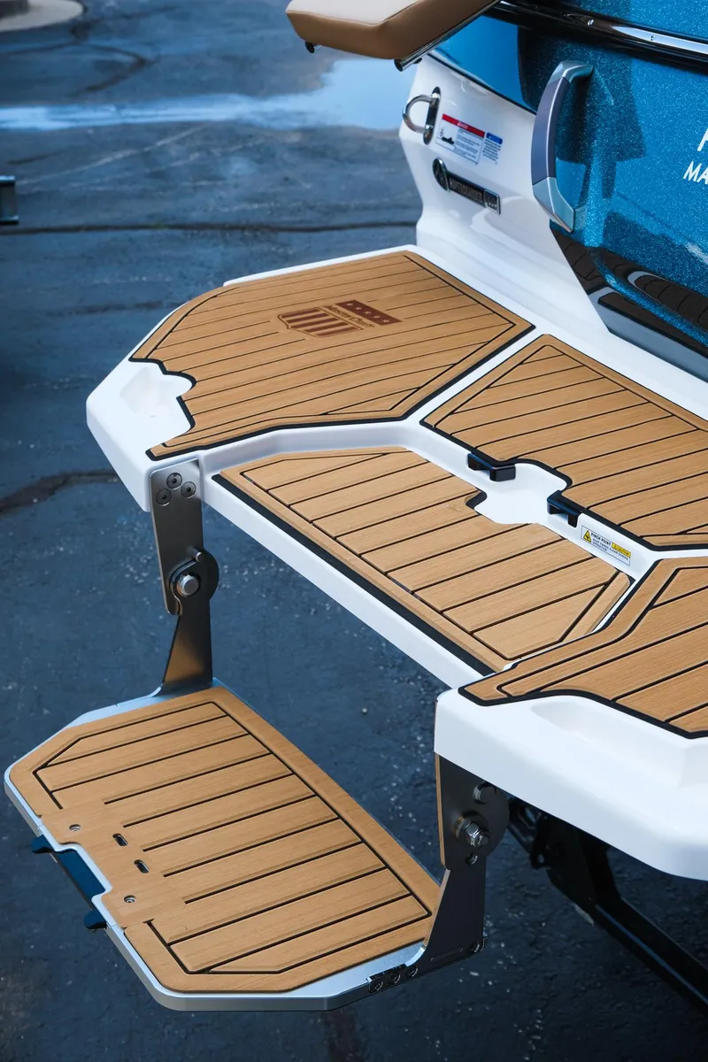 Slide: The Image of 2025 MasterCraft X26 swim platform with teak-style decking and fold-down step. - 10