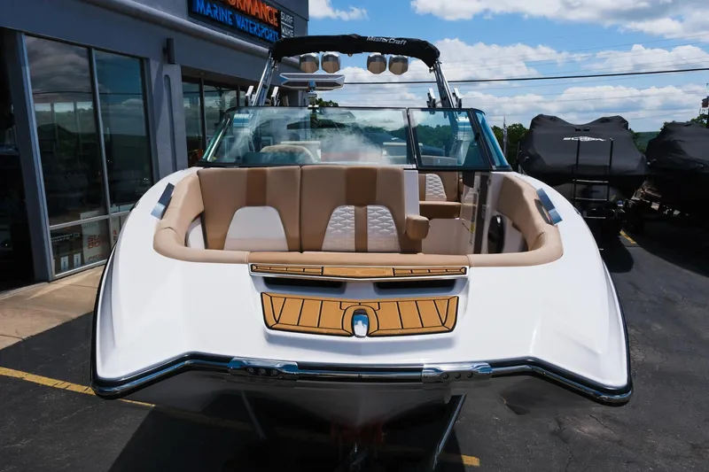 Slide: The Image of 2025 MasterCraft X26 boat with luxurious seating, displayed outdoors. - 14