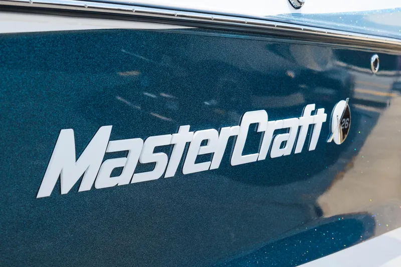 Slide: The Image of 2025 MasterCraft X26 boat logo on a sleek blue hull. - 15