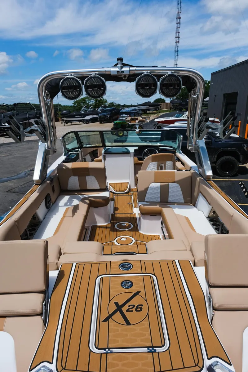Slide: The Image of 2025 MasterCraft X26 boat interior with luxurious seating and advanced audio system. - 16