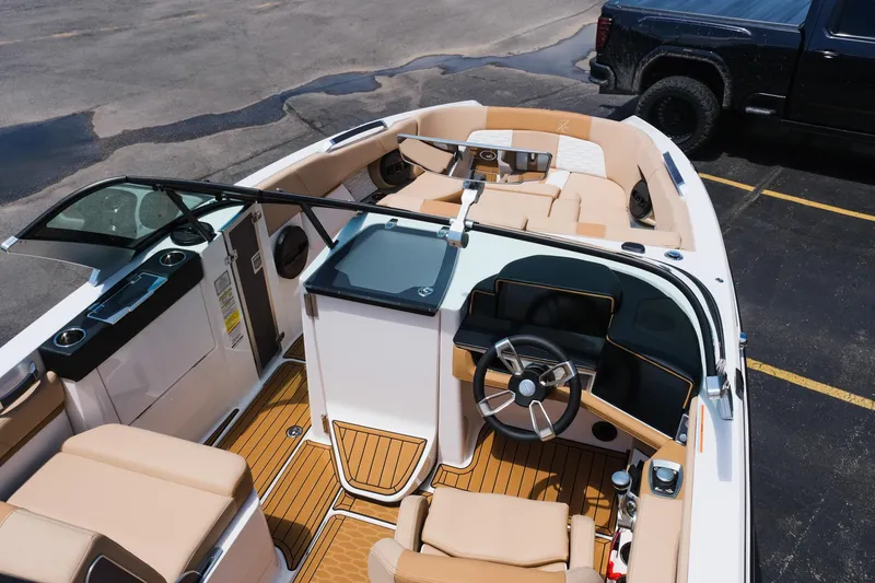 Slide: The Image of 2025 MasterCraft X26 boat interior with tan seating and modern dashboard. - 17