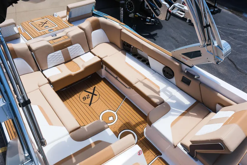Slide: The Image of 2025 MasterCraft X26 boat interior with luxurious seating and teak flooring. - 22