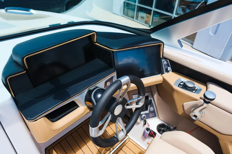 Slide: The Image of 2025 MasterCraft X26 boat dashboard with modern steering wheel and digital display. - 26