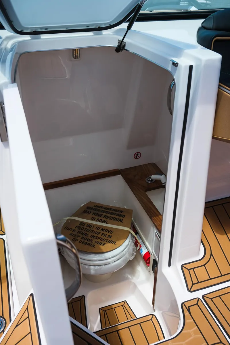 Slide: The Image of 2025 MasterCraft X26 boat interior with storage compartment and wooden flooring. - 27