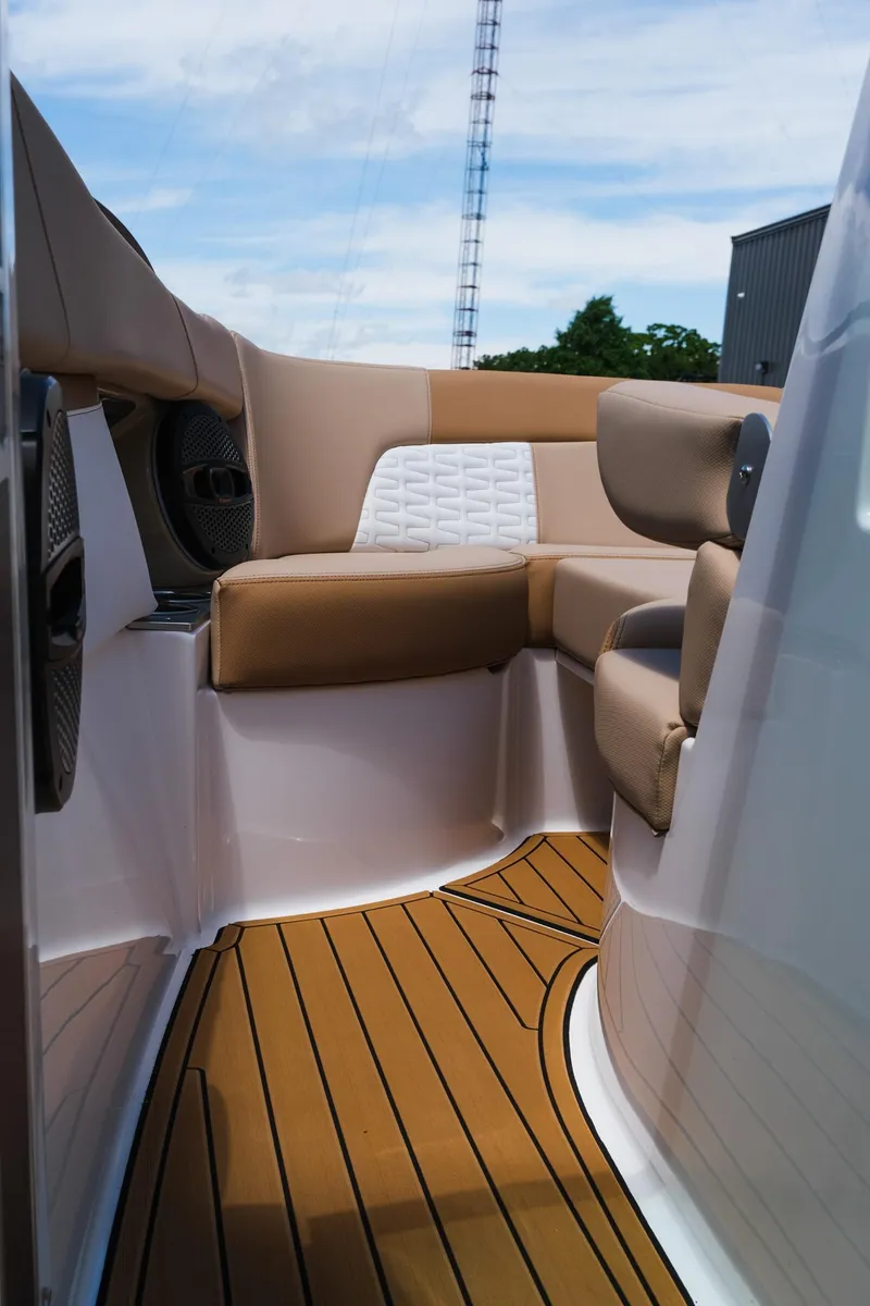 Slide: The Image of 2025 MasterCraft X26 boat interior with tan seating and teak flooring. - 29