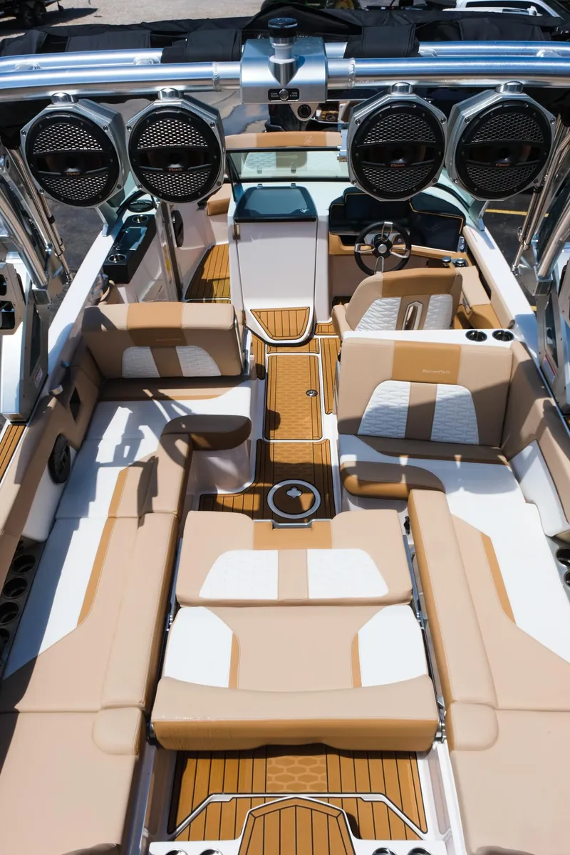 Slide: The Image of 2025 MasterCraft X26 boat interior with luxurious seating and advanced audio system. - 36