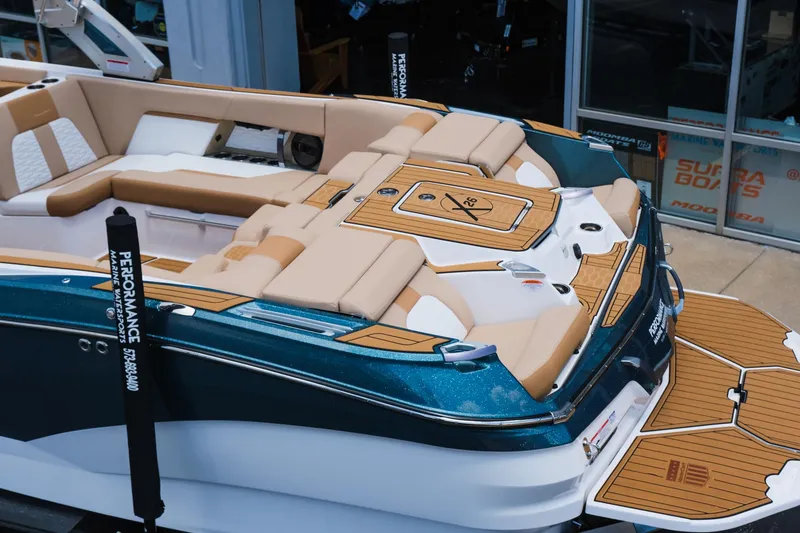 Slide: The Image of 2025 MasterCraft X26 boat with luxurious seating and teak-style decking. - 6