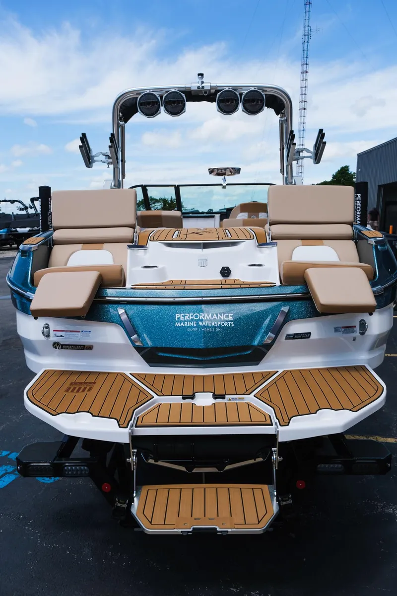 Slide: The Image of 2025 MasterCraft X26 boat with teak deck, luxurious seating, and modern design. - 9