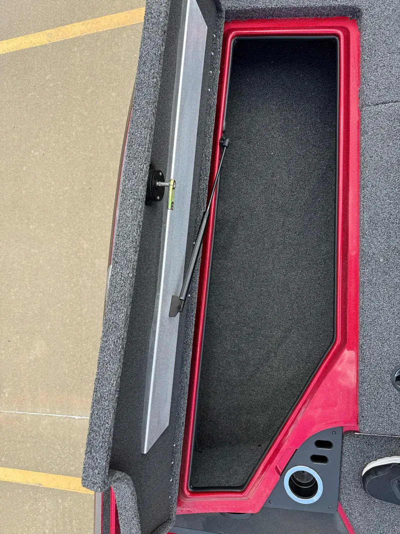Slide: The Image of Open storage compartment in a 2020 Nitro Z18 Pro boat, featuring red and gray interior. - 14