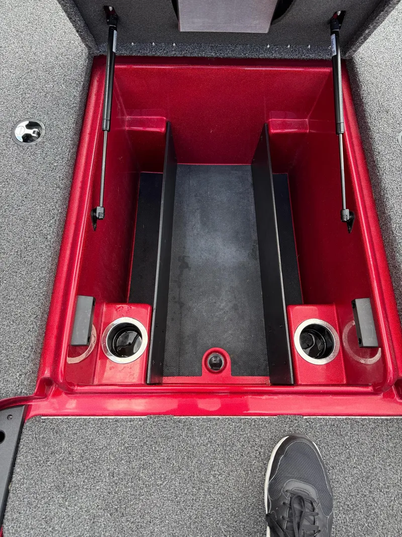 Slide: The Image of Open storage compartment in a 2020 Nitro Z18 Pro boat, featuring red interior and cup holders. - 15