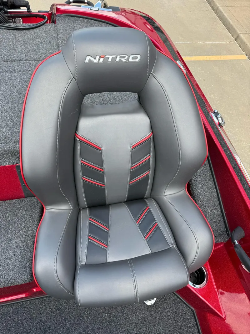 Slide: The Image of Gray and red Nitro Z18 Pro boat seat, 2020 model, on a red boat deck. - 18