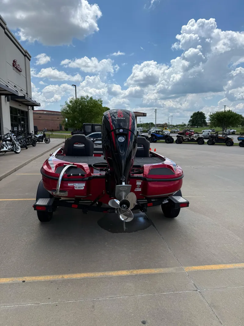 Slide: The Image of Red 2020 Nitro Z18 Pro boat with outboard motor in parking lot under cloudy sky. - 7