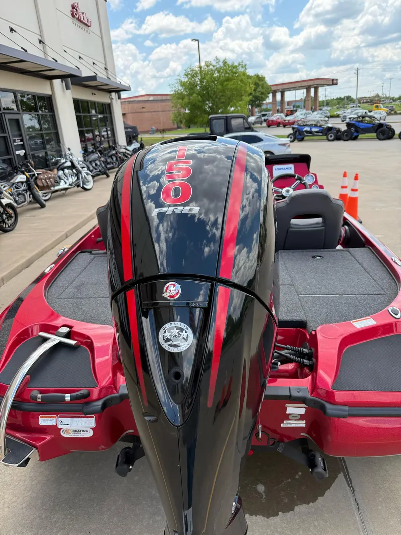 Slide: The Image of Red Nitro Z18 Pro boat with 150 HP engine, parked outside dealership, 2020 model. - 9