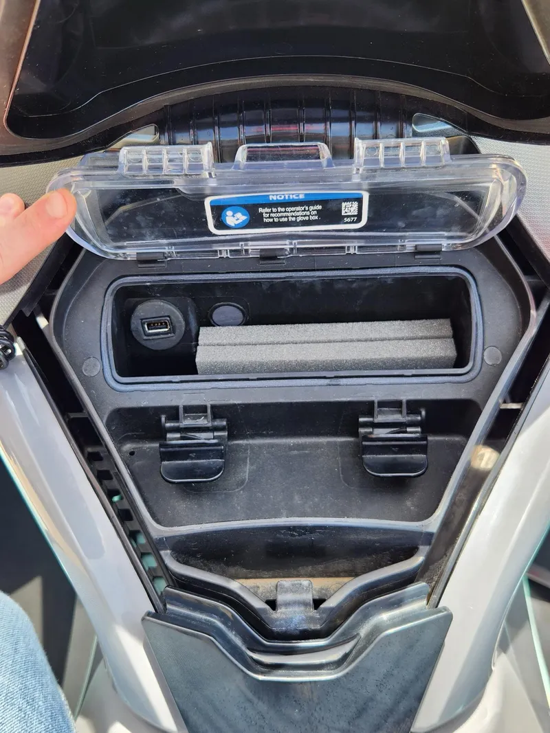 Slide: The Image of 2022 Sea-Doo Wake Pro 230 storage compartment with USB port and protective cover. - 14