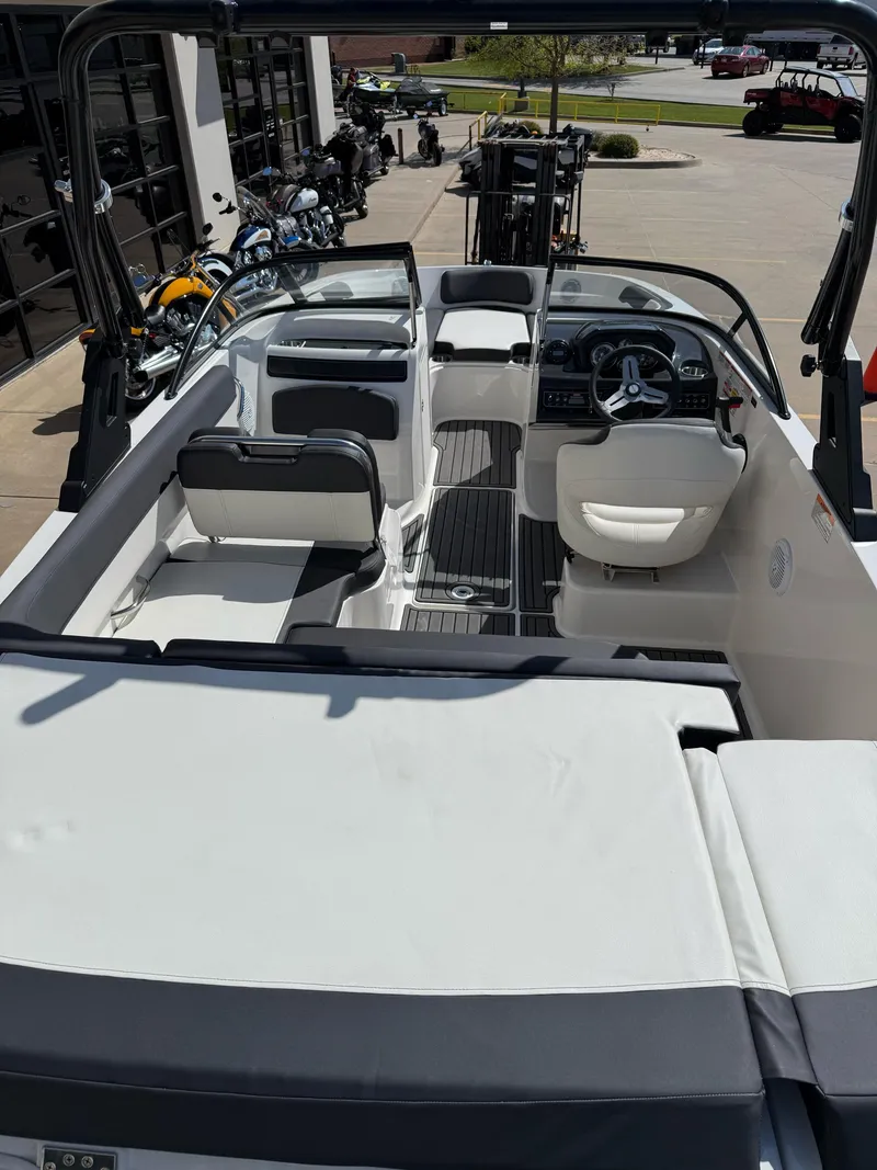 Slide: The Image of 2021 Bayliner VR5 Bowrider I/O interior with seating and steering wheel, parked outdoors. - 10