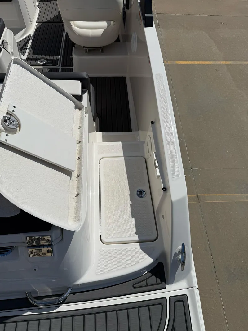 Slide: The Image of 2021 Bayliner VR5 Bowrider I/O interior with open storage compartment and seating. - 11