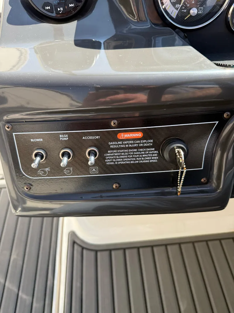 Slide: The Image of Control panel of 2021 Bayliner VR5 Bowrider I/O with switches and ignition key. - 14