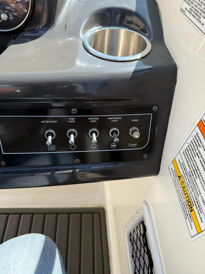 Slide: The Image of Control panel of a 2021 Bayliner VR5 Bowrider I/O with switches and cup holder. - 15