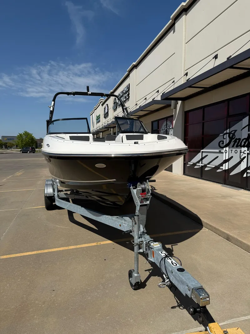 Slide: The Image of 2021 Bayliner VR5 Bowrider I/O on trailer outside dealership, sunny day. - 3
