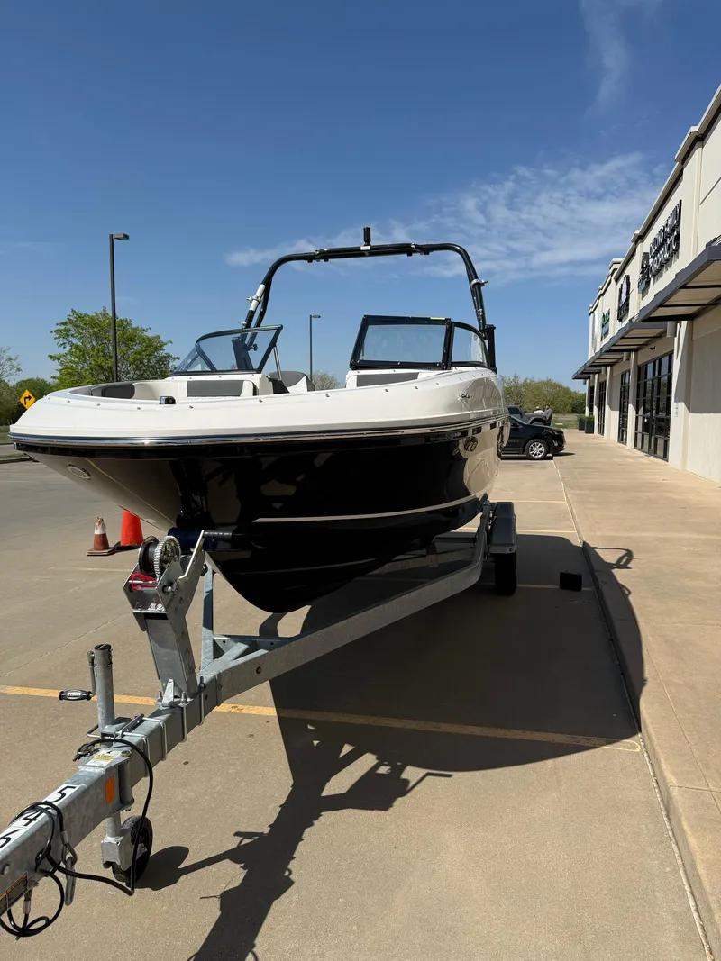 Slide: The Image of 2021 Bayliner VR5 Bowrider I/O on trailer, parked outside a building under clear skies. - 4