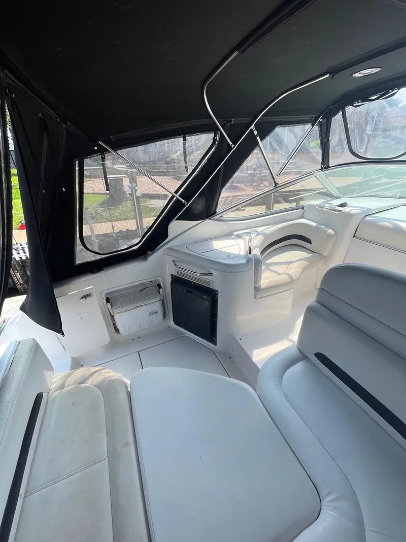Slide: The Image of 2003 Chaparral Signature 290 boat interior with seating and black canopy. - 4