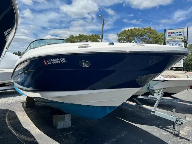 The Image of 2011 Sea Ray 250 SLX boat on trailer, blue and white exterior, parked outdoors. - 0