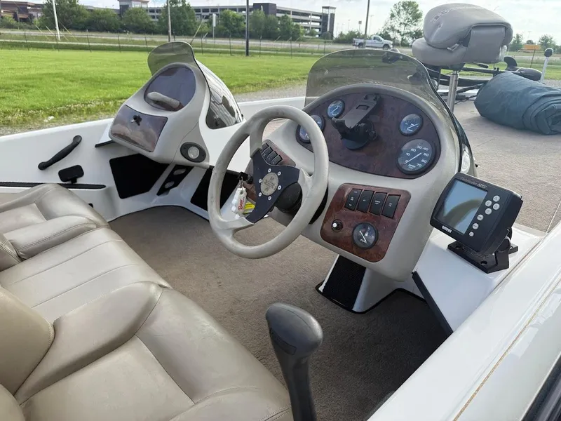 Slide: The Image of 2003 Ranger 185 VS boat interior with steering wheel, gauges, and seating. - 4