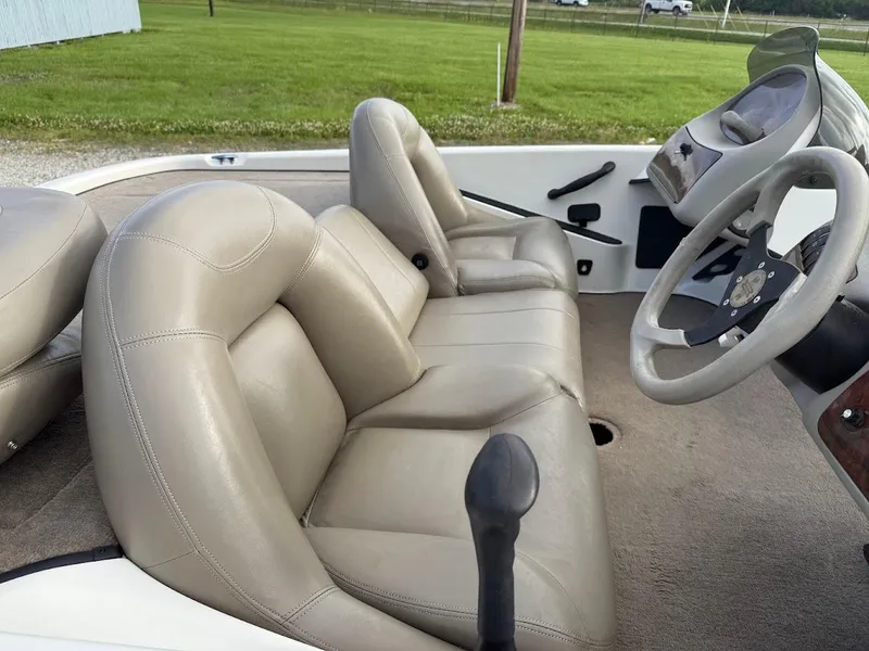 Slide: The Image of 2003 Ranger 185 VS boat interior with beige leather seats and steering wheel. - 5