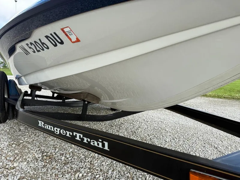 Slide: The Image of 2003 Ranger 185 VS boat on RangerTrail trailer, parked on gravel. - 7