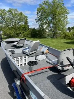 Slide: The Image of 1979 Sea Nymph Jon boat with seating, parked outdoors on a sunny day. - 5