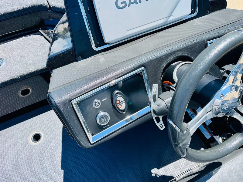 Slide: The Image of 2024 Ranger Z520R boat dashboard with steering wheel and control panel. - 37