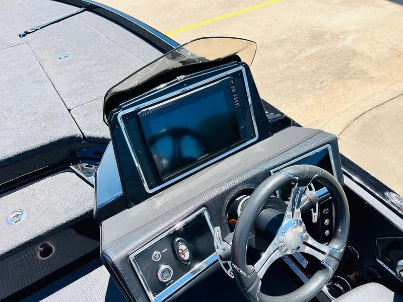 Slide: The Image of 2024 Ranger Z520R boat dashboard with steering wheel and large display screen. - 38
