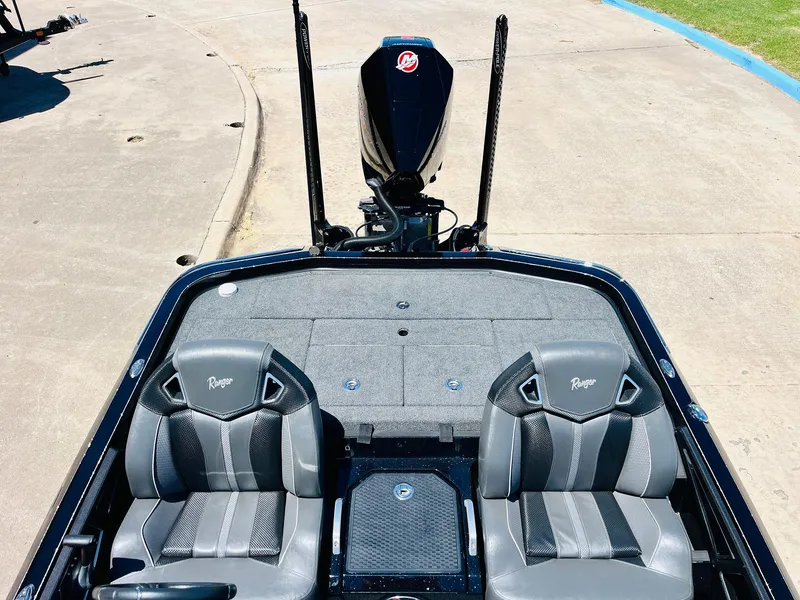 Slide: The Image of 2024 Ranger Z520R Ranger Cup boat with dual seats and motor, parked on concrete. - 40