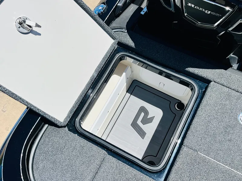 Slide: The Image of 2024 Ranger Z520R Ranger Cup Equipped boat storage compartment with open lid. - 45