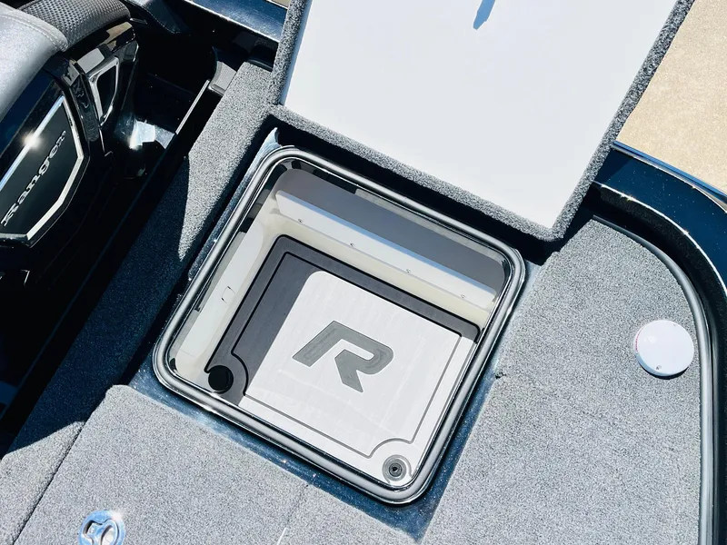 Slide: The Image of 2024 Ranger Z520R Ranger Cup Equipped storage compartment with logo, open lid, and carpeted interior. - 48