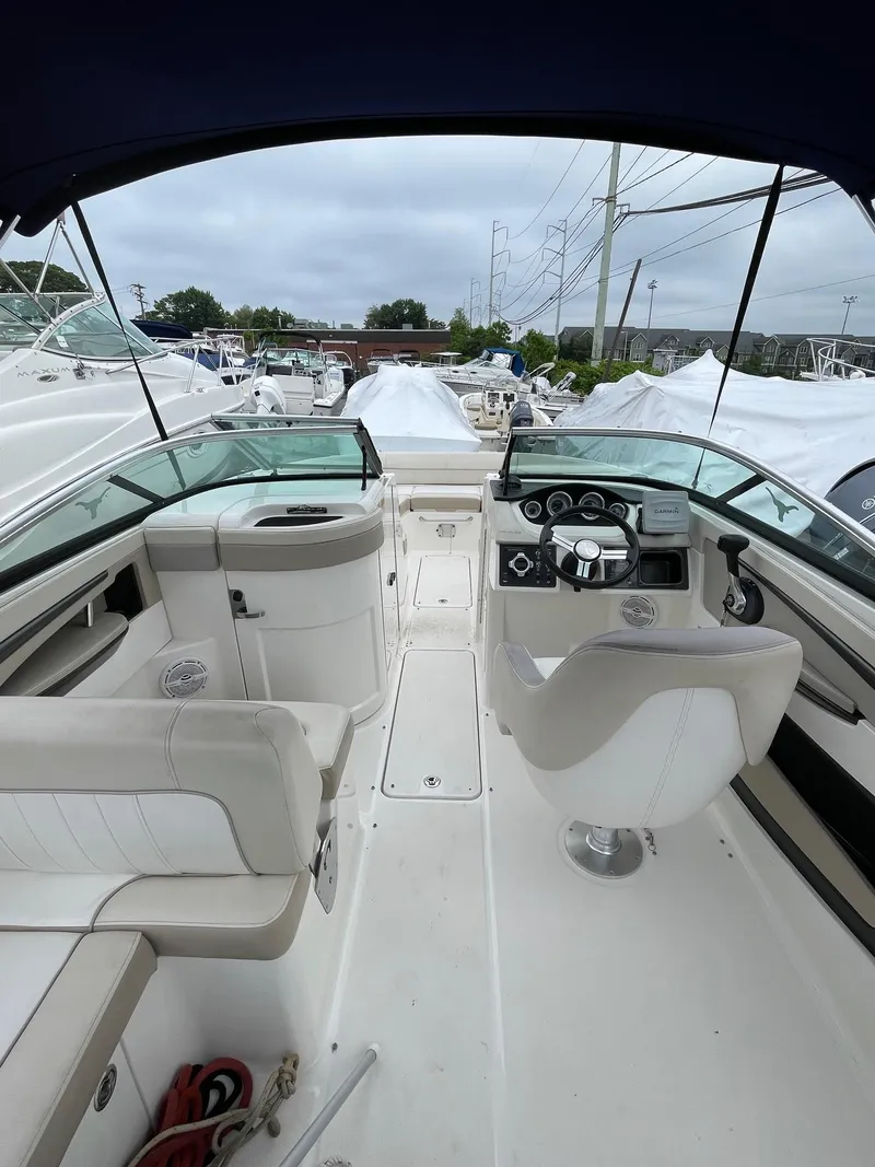 Slide: The Image of 2013 Sea Ray 240 Sundeck interior with helm, seating, and dashboard. - 11