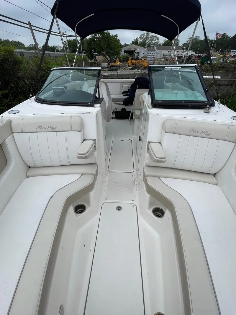 Slide: The Image of 2013 Sea Ray 240 Sundeck boat interior with white seating and open deck layout. - 13