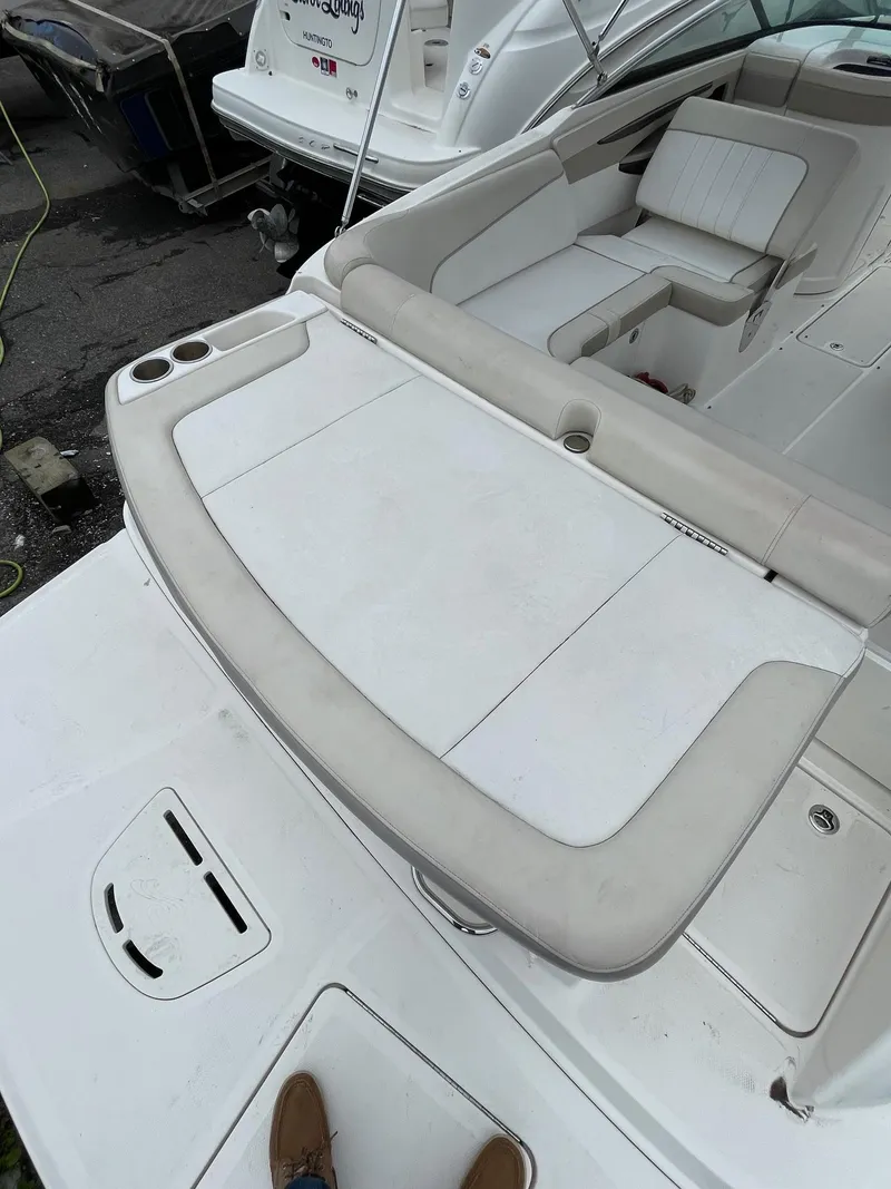 Slide: The Image of 2013 Sea Ray 240 Sundeck boat interior with seating and storage compartments. - 16