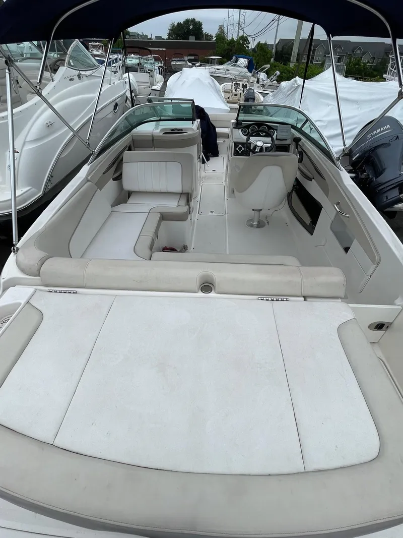Slide: The Image of 2013 Sea Ray 240 Sundeck boat with spacious seating and sleek design. - 17