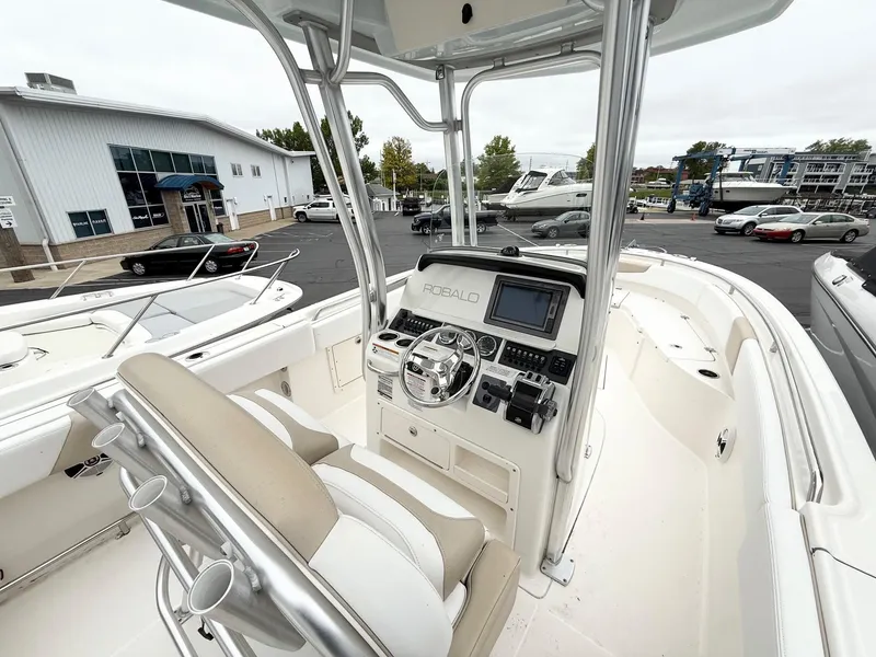 Slide: The Image of 2018 Robalo R242 Explorer boat interior with helm, steering wheel, and seating. - 10