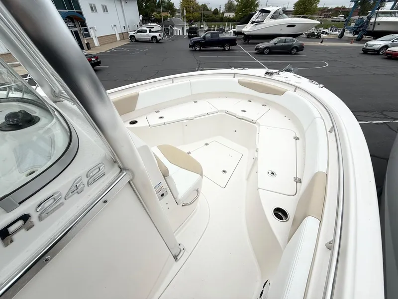 Slide: The Image of 2018 Robalo R242 Explorer boat deck with seating and storage compartments. - 11