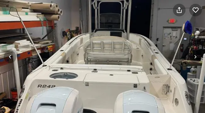 Slide: The Image of 2018 Robalo R242 Explorer boat in a workshop, rear view with dual engines. - 13