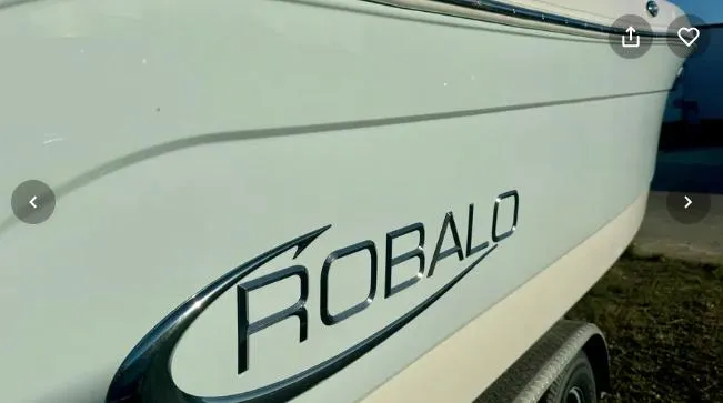 Slide: The Image of 2018 Robalo R242 Explorer boat side view with logo. - 17