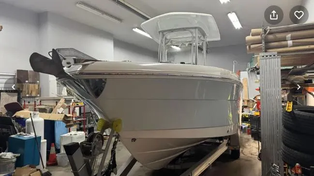 Slide: The Image of 2018 Robalo R242 Explorer boat in a storage facility. - 2