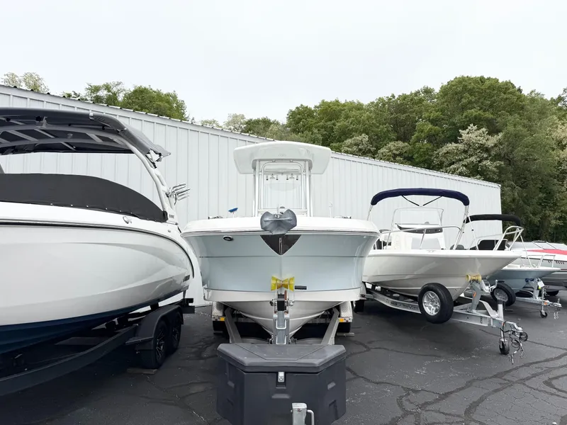 Slide: The Image of 2018 Robalo R242 Explorer boat displayed outdoors, surrounded by other boats. - 4
