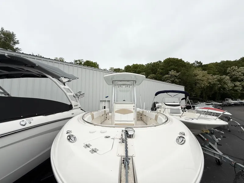 Slide: The Image of 2018 Robalo R242 Explorer boat displayed outdoors, surrounded by other boats. - 5