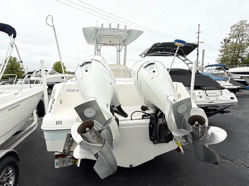 Slide: The Image of 2018 Robalo R242 Explorer boat with dual outboard engines, docked in a marina. - 7