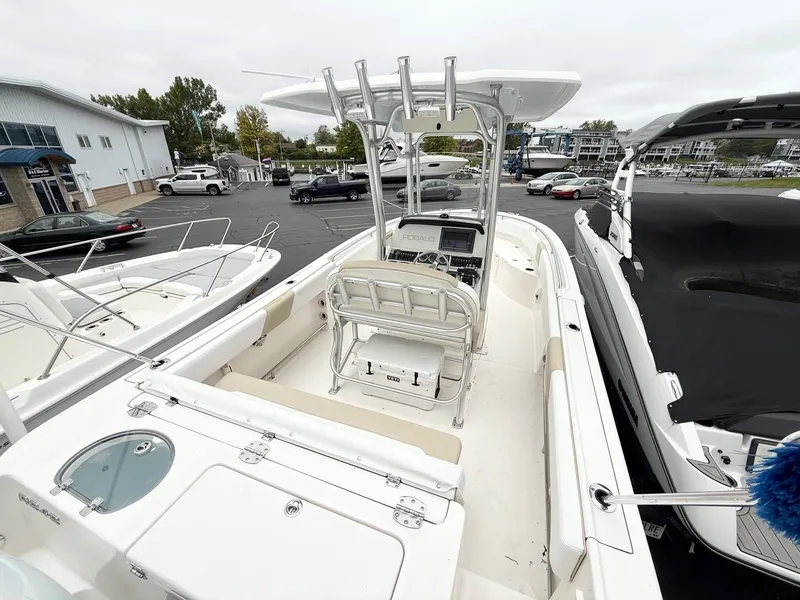 Slide: The Image of 2018 Robalo R242 Explorer boat with center console in a marina setting. - 8